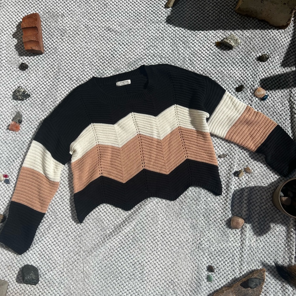 Black, white, and pink knitted zigzag sweater